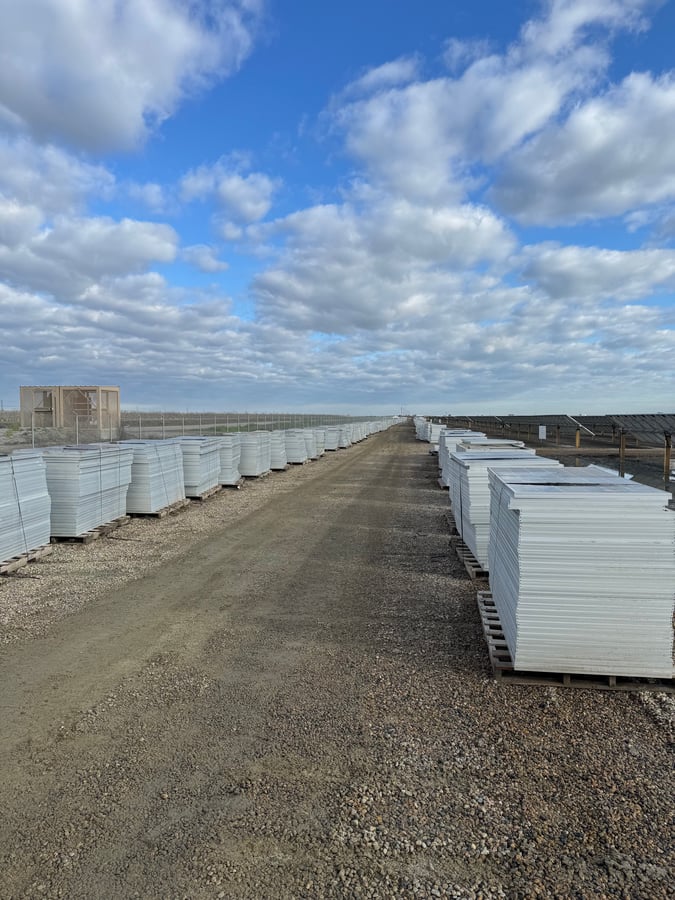 Comstock Metals field team palletizing panels on an active solar site
