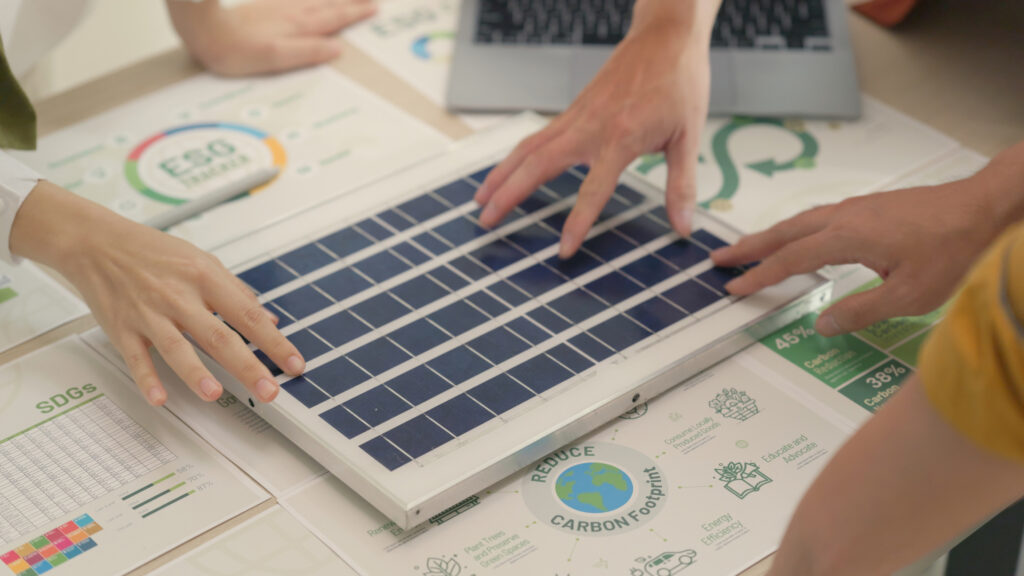 Image of people touching a miniature solar panel 